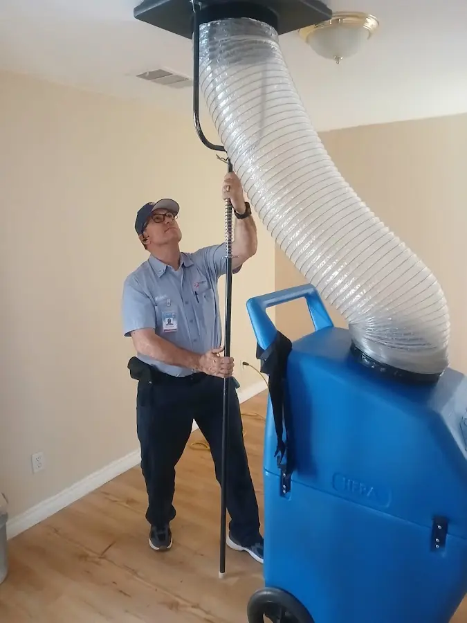 Furnace Tune-Up technician using HEPA equipment in Lakewood